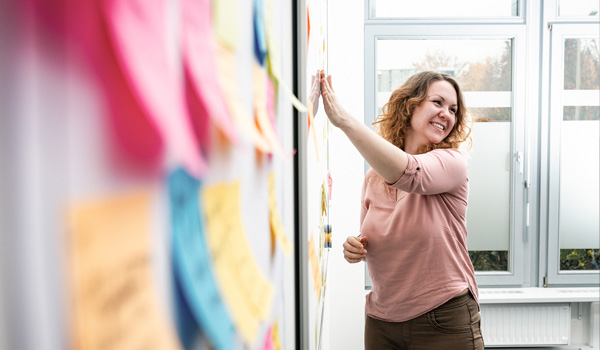 Woman pointing at whiteboard